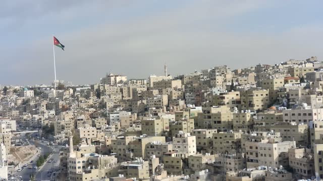 Raghadan Flagpole Stand Above Crowded Buildings in the City of Amman