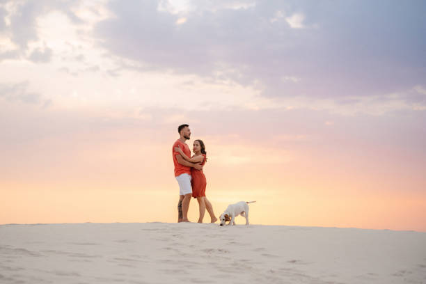 istock young couple in orange clothes with dog 1465504440