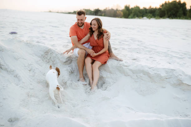 istock young couple in orange clothes with dog 1465504702