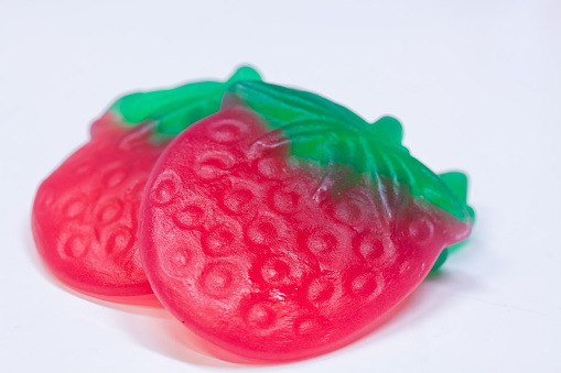 A closeup shot of gummy strawberry candies isolated on a white background