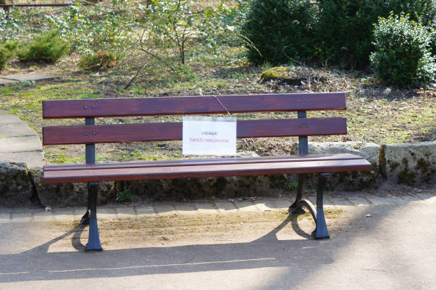 istock Wooden bench with a fresh painted warning sign 1465506306