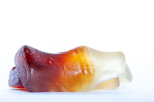 Image of a set of dentures, with one tooth that fell out. Photographed on a white background         
