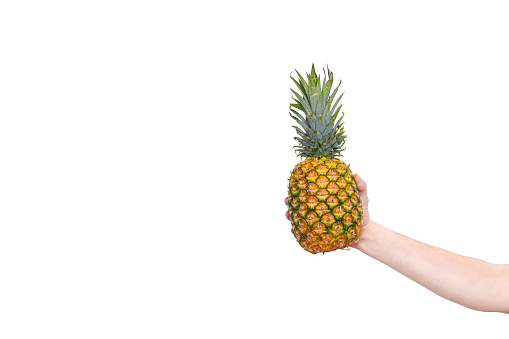 Studio shot of a beautiful young woman posing with a pineapple