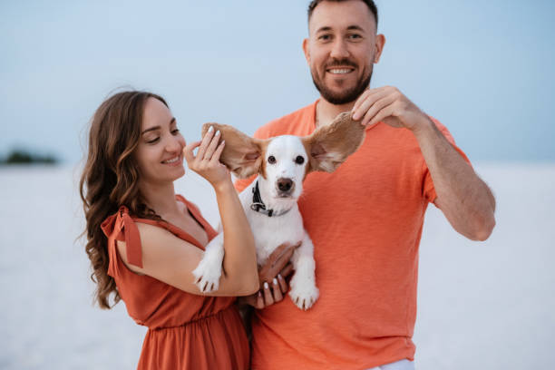 istock young couple in orange clothes with dog 1465507006