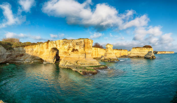 istock Stunning seascape with cliffs rocky arch and stacks (faraglioni) at Torre Sant Andrea 1465507025