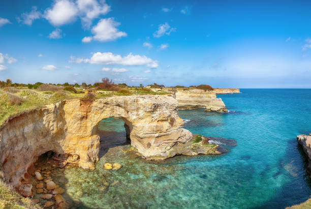 istock Stunning seascape with cliffs rocky arch and stacks (faraglioni) at Torre Sant Andrea 1465507958