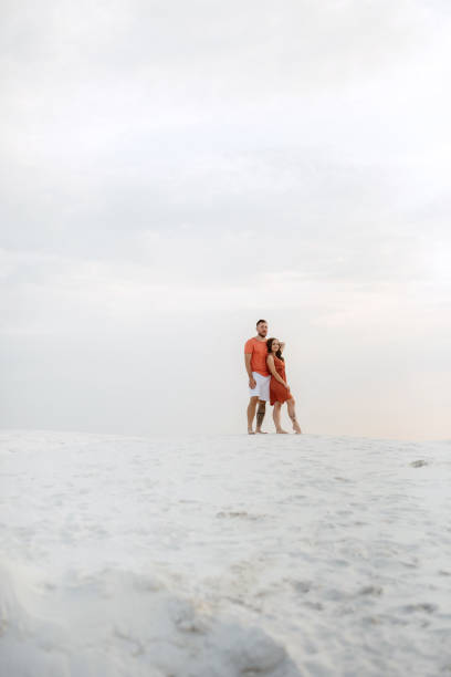istock young couple in orange clothes with dog 1465508445