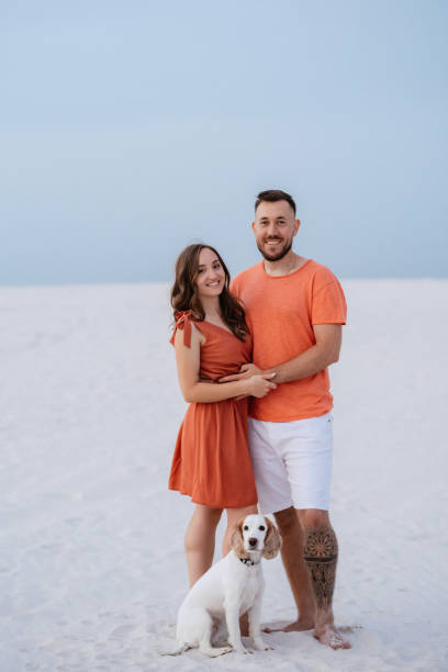 istock young couple in orange clothes with dog 1465508722