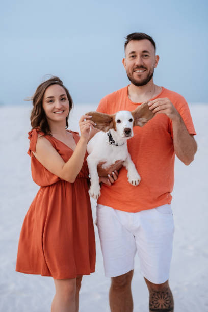 istock young couple in orange clothes with dog 1465509124