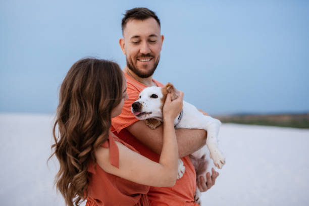 istock young couple in orange clothes with dog 1465509458