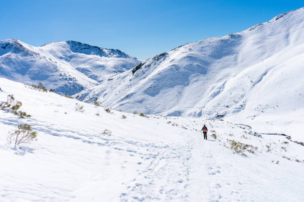 istock snowshoe mountaineer descends path into snowy mountains 1465509976