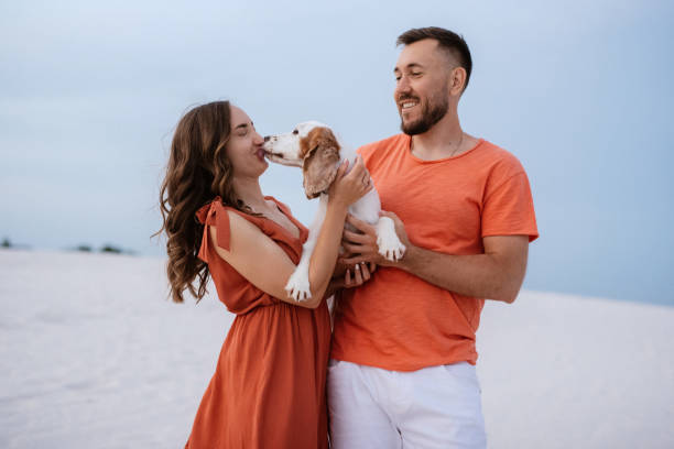 istock young couple in orange clothes with dog 1465510054