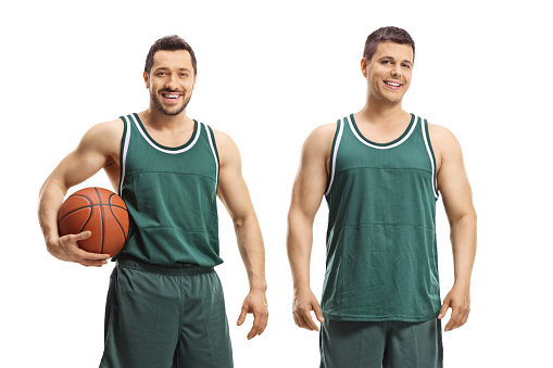 Basketball players posing with a ball isolated on white background