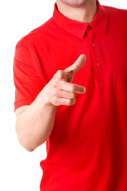 istock Man with a red t-shirt pointing at the camera on a white background 1465510754