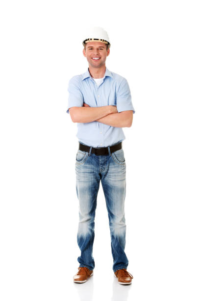 istock Young happy engineer in a helmet standing with crossed hands 1465510784