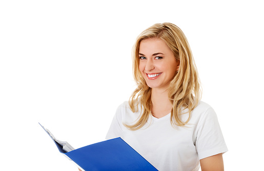 A Caucasian blonde woman from Poland holding a folder and smiling on white background