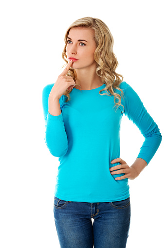 A blonde thinking Polish woman in blue clothes isolated on white background