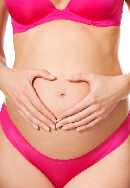 istock Young pregnant woman posing on a white background 1465510958