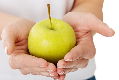 A close up of a green apple in hands