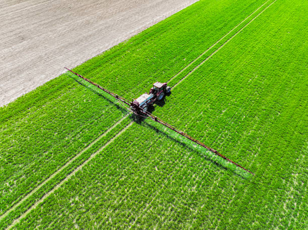 istock Tractor with an agriculutural crops sprayer from above 1465511736
