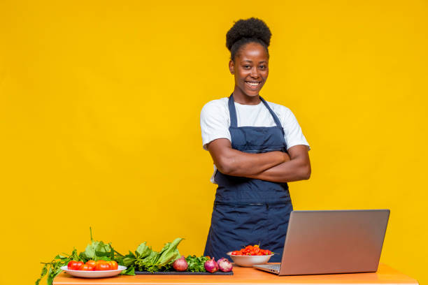istock African female chef posing in front of a yellow wall 1465511748