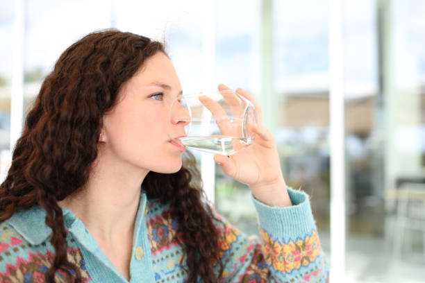 Woman drinking water in a restaurant terrace