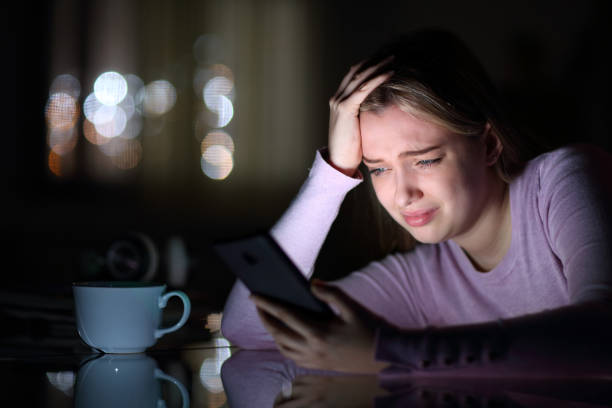 istock Sad teen crying checking phone in the night 1465512020