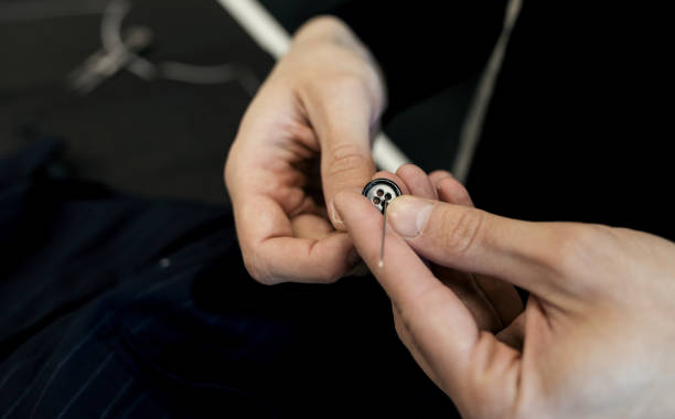 istock Sewing the buttons to the jacket. 1465512031