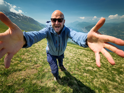 Happy Man Hike on top of the Monte Baldo with the Lake Garda at the background