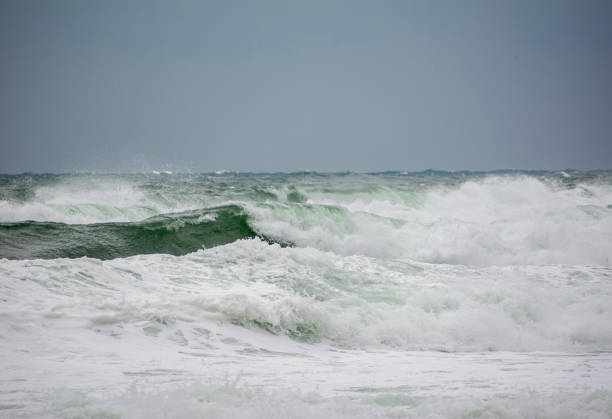 istock Scenic view of ocean waves on a blue sky backgroun 1465512241