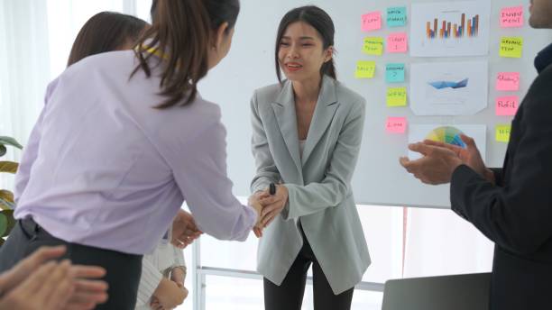 istock Businesswoman proficiently present work project receive celebrations from team . Corporate business team collaboration concept . 1465513163