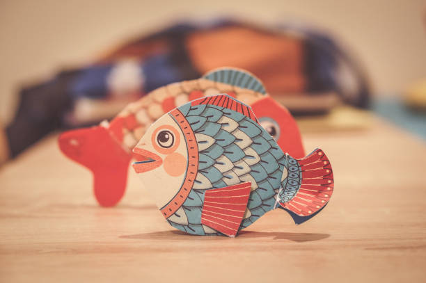Colorful silicone fishing baits with plummets on wooden table.