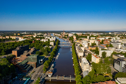 Aerial drone view overlooking the Aurajoki river, summer morning in Turku, Finland