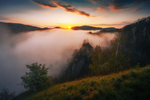 A beautiful sunrise in mountains with white fog