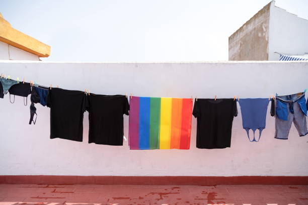 istock Clothes and a colorful flag hanging to dry 1465516250