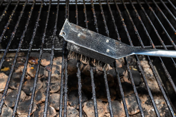 istock Cleaning a dirty grill while standing on the terrace and emptying the ashes. 1465516549