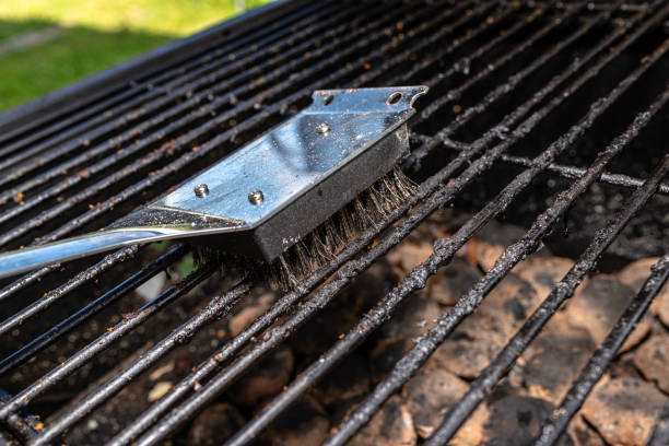 istock Cleaning a dirty grill while standing on the terrace and emptying the ashes. 1465516553