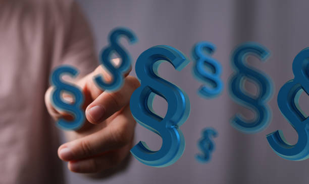 istock 3D rendered paragraph law blue signs in the male hand 1465517852