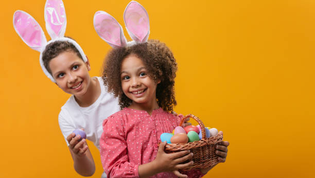 istock A children with rabbit ears on her head with a basket full of Easter eggs 1465518748