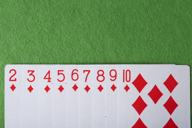 Playing cards of diamonds on a green background.
