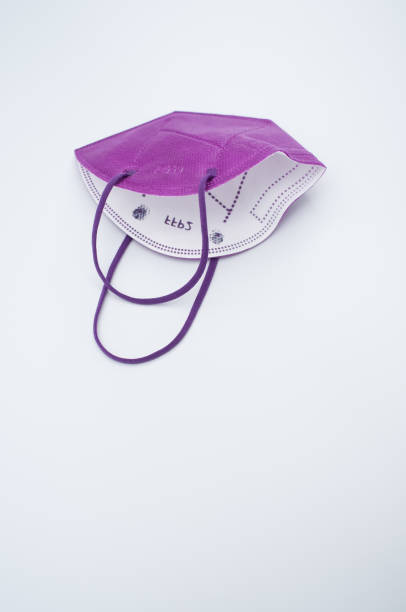 istock Isolated respiratory medical mask on a white background 1465519978