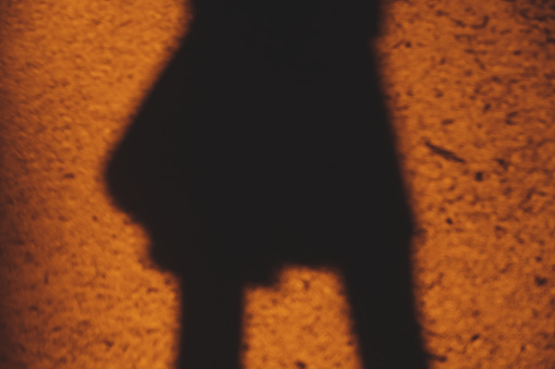 Silhouette woman is showing biceps.