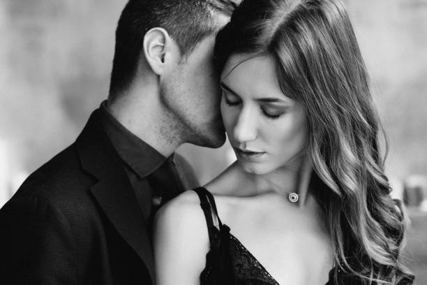istock the guy hugs the girl from behind, she tilted her head 1465520256