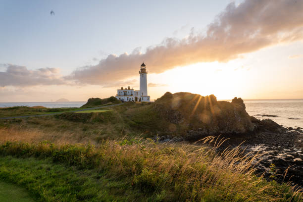 istock Scenic view of a lighthouse on a rocky shore at sunset 1465520524
