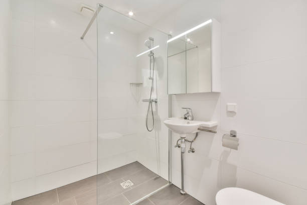 istock Interior of a white bathroom with a shower and a sink 1465520536