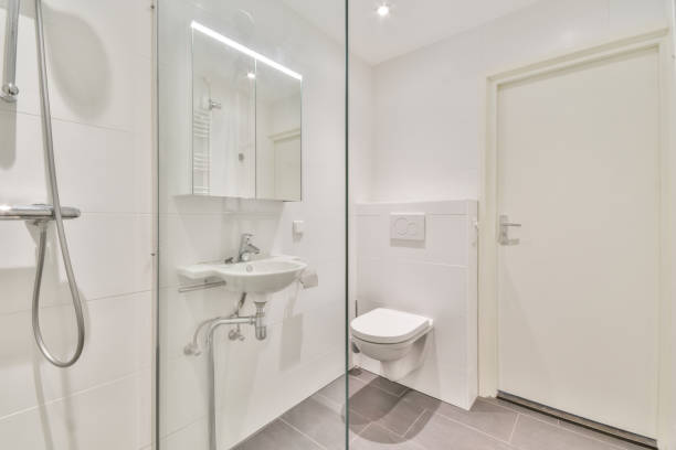 istock Interior of a white bathroom with a shower and a sink 1465520540
