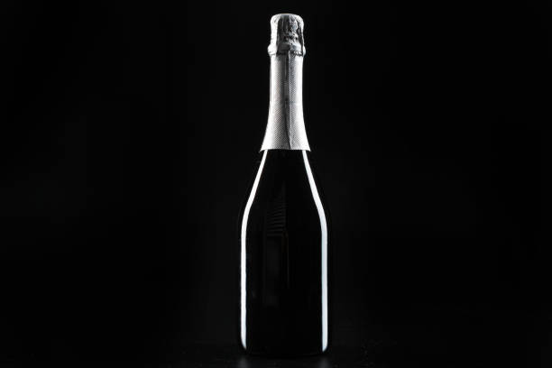 istock Champagne bottle on dark black background close up 1465520751