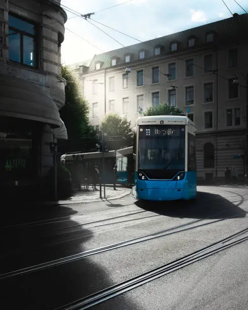 A vertical shot of a trolleybus on the rails surrounded by buildings in Gothenburg, Sweden