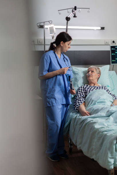 istock Nurse discussing with elderly patient during visit about chest x-ray 1465521984