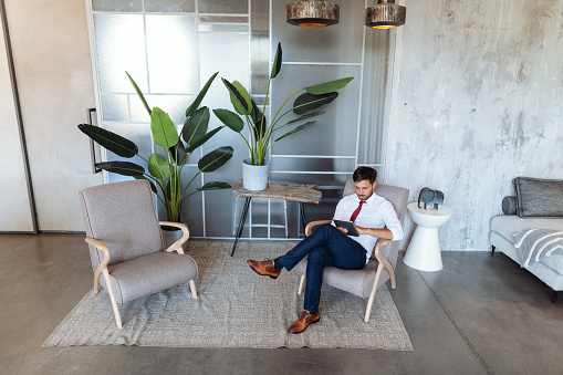 Man in living room with digital tablet